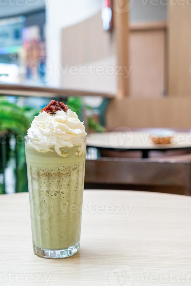 Matcha green tea latte blended with whipped cream and red bean in coffee shop cafe and restaurant photo