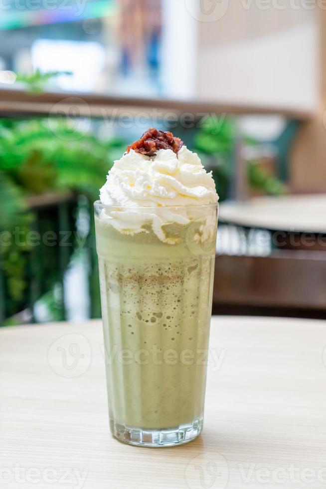 Matcha green tea latte blended with whipped cream and red bean in coffee shop cafe and restaurant photo