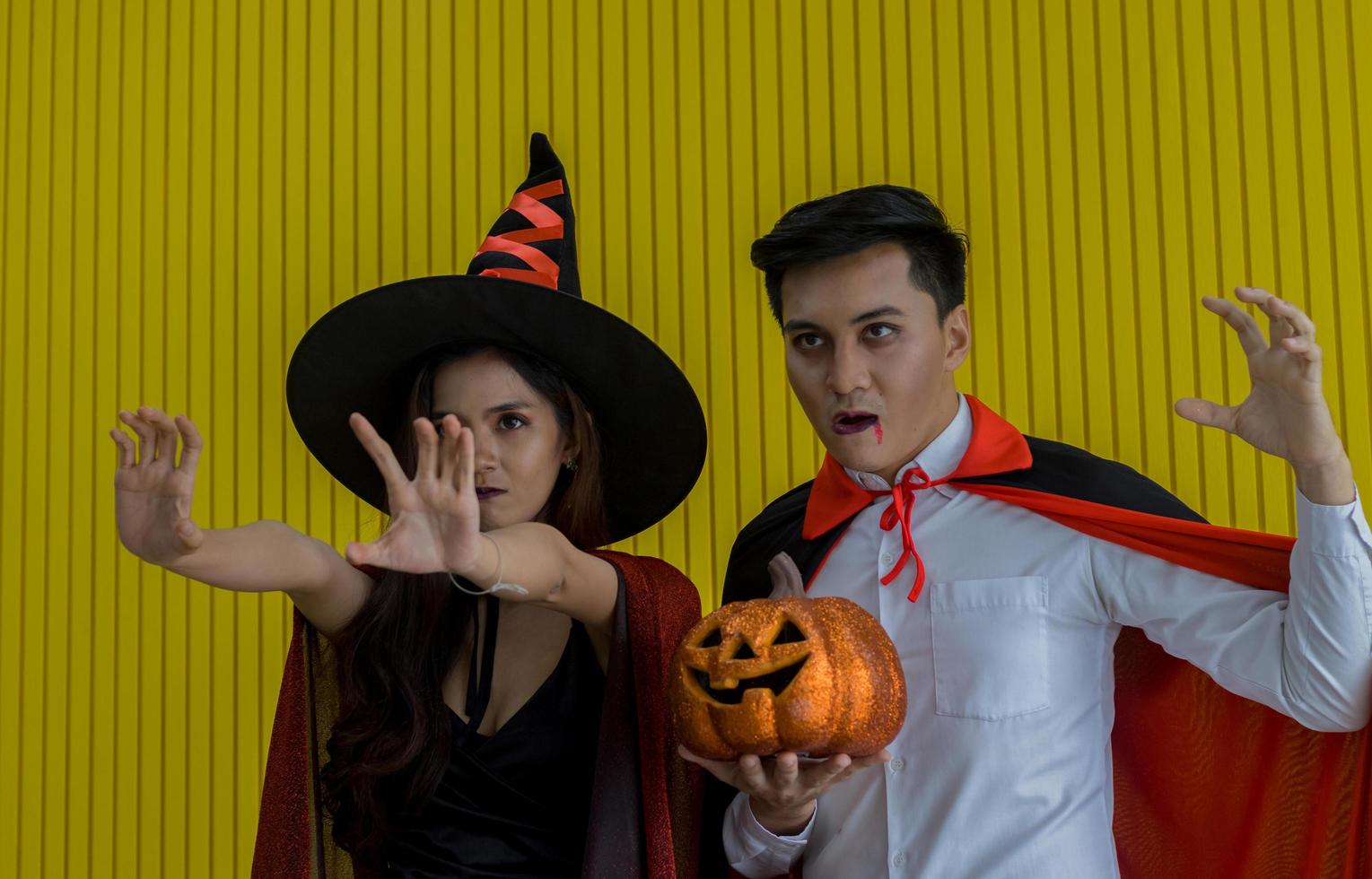 Young men are having fun drinking and celebrating the party HalloweenWith orange pumpkin photo