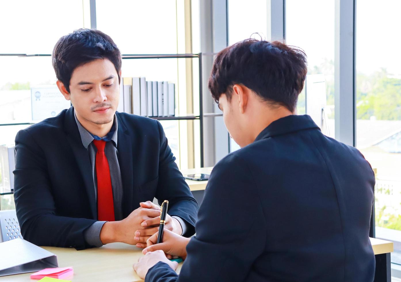 Businessmen sitting in a modern office They are active young businessmen photo