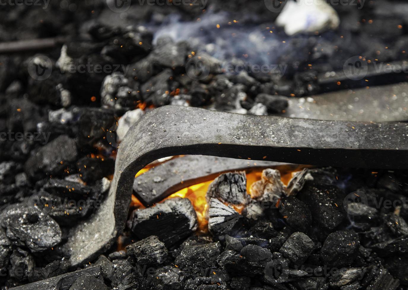 Iron incandescent in an old metal forge photo