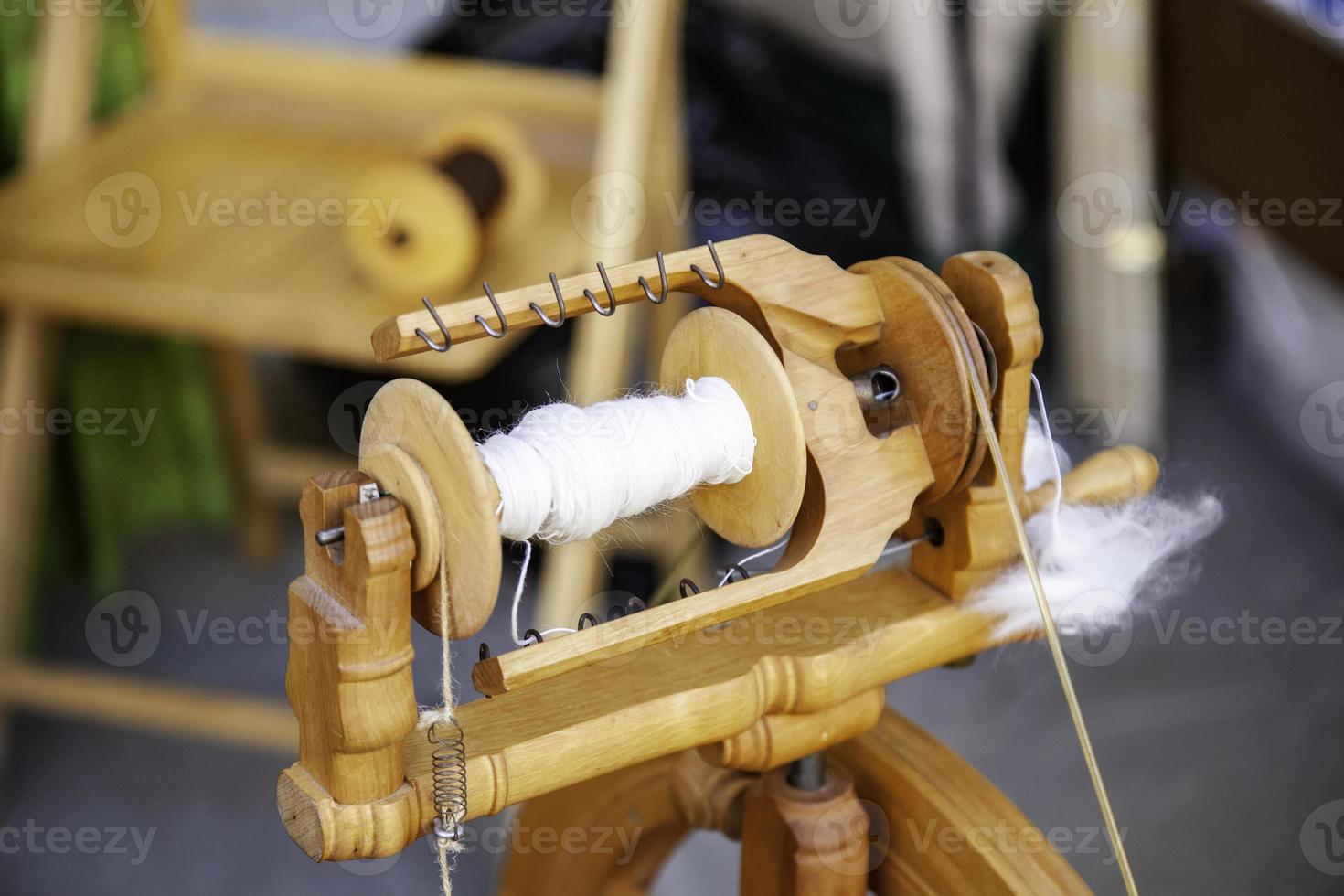 Spinning with a wooden spinning wheel photo