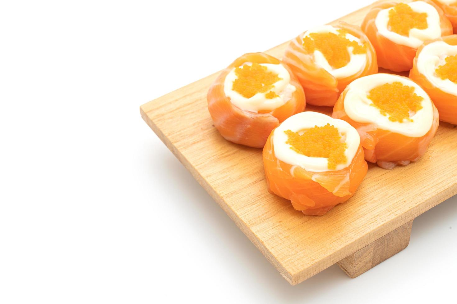 Fresh salmon sushi roll with mayonnaise and shrimp egg - Japanese food style photo