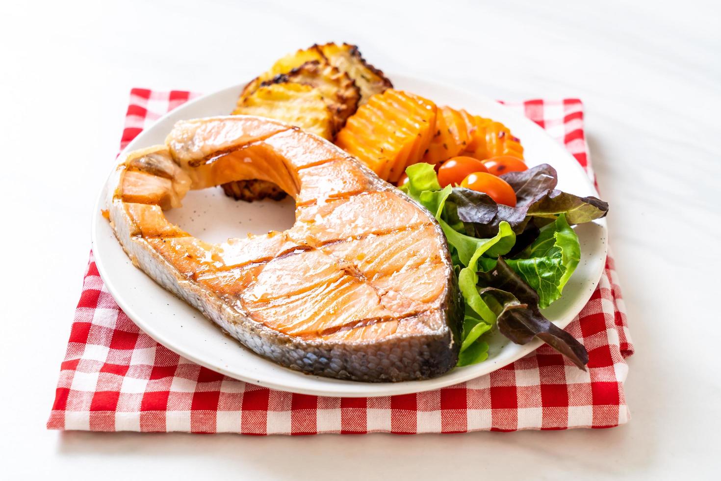 Double grilled salmon steak fillet with vegetable and french fries photo