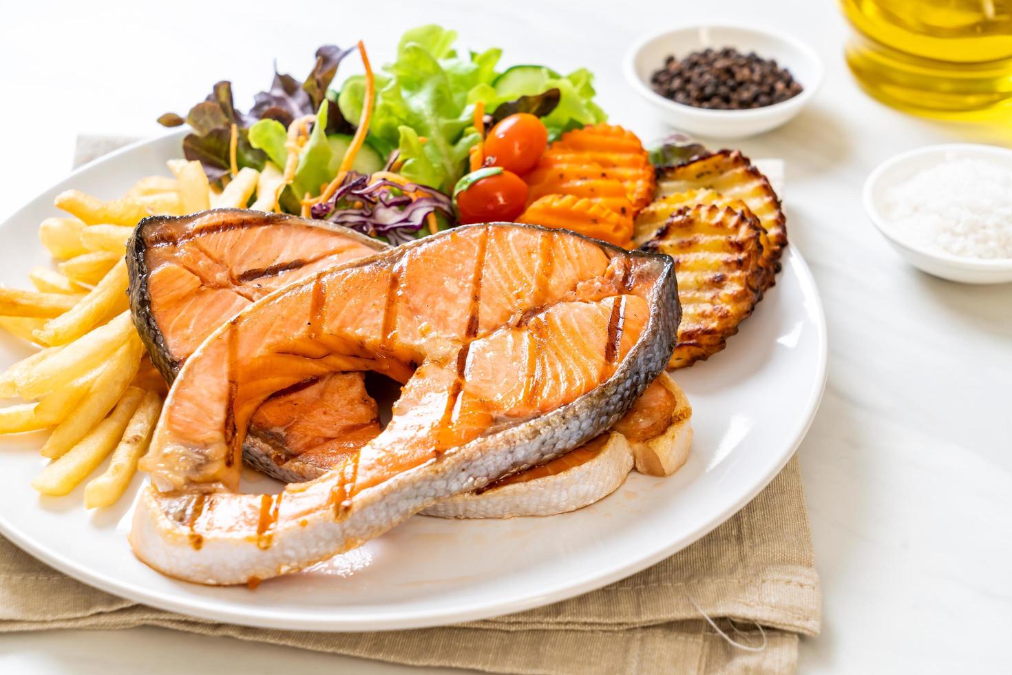 Double grilled salmon steak fillet with vegetable and french fries photo