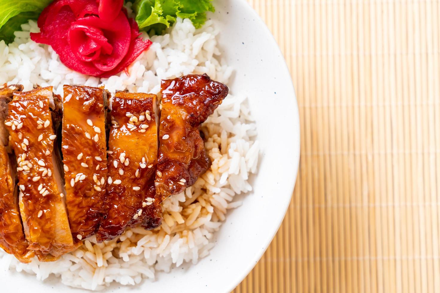 Grilled chicken with teriyaki sauce on topped rice bowl photo