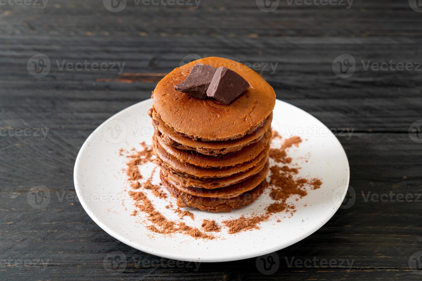 Chocolate pancake stack with chocolate powder photo