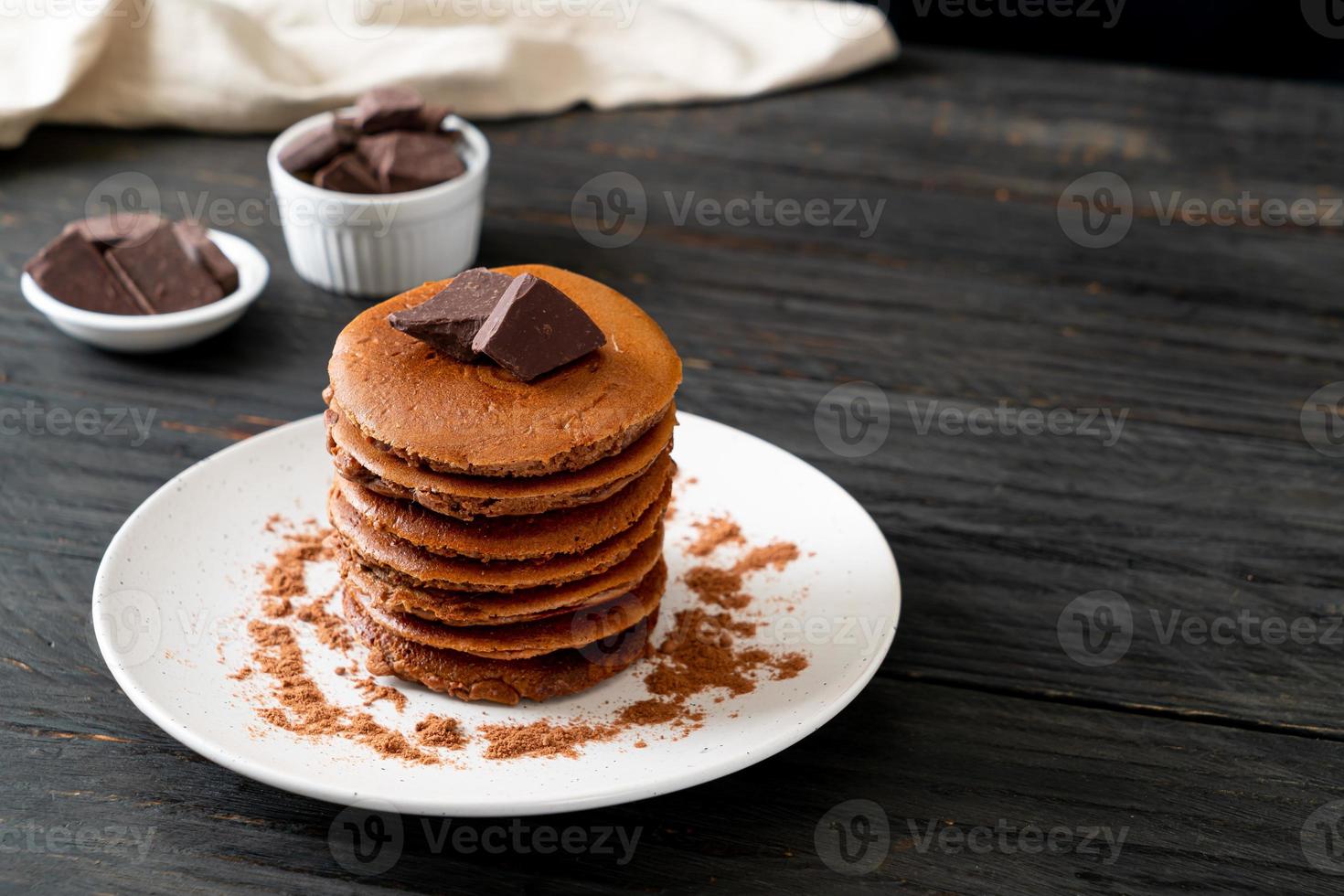 Chocolate pancake stack with chocolate powder photo