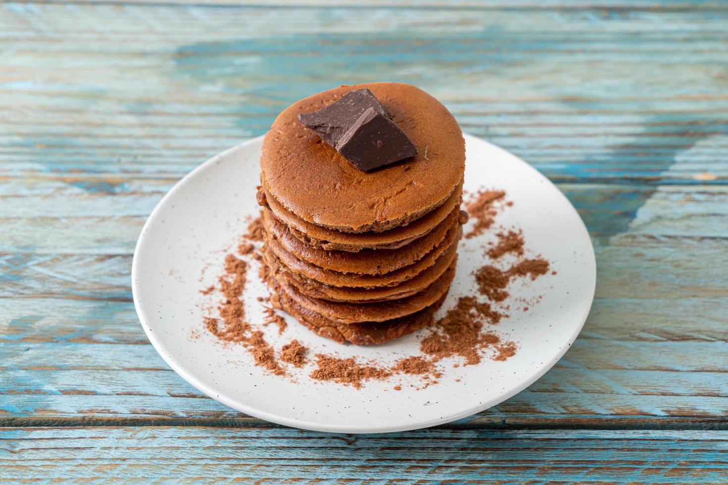 Chocolate pancake stack with chocolate powder photo