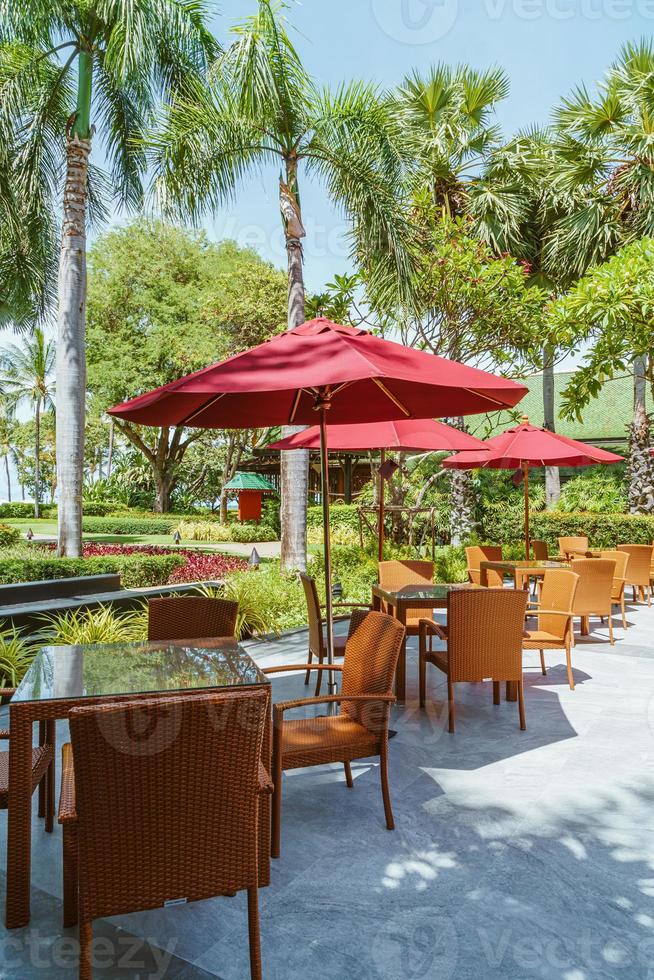 Empty outdoor patio table and chair with umbrella photo