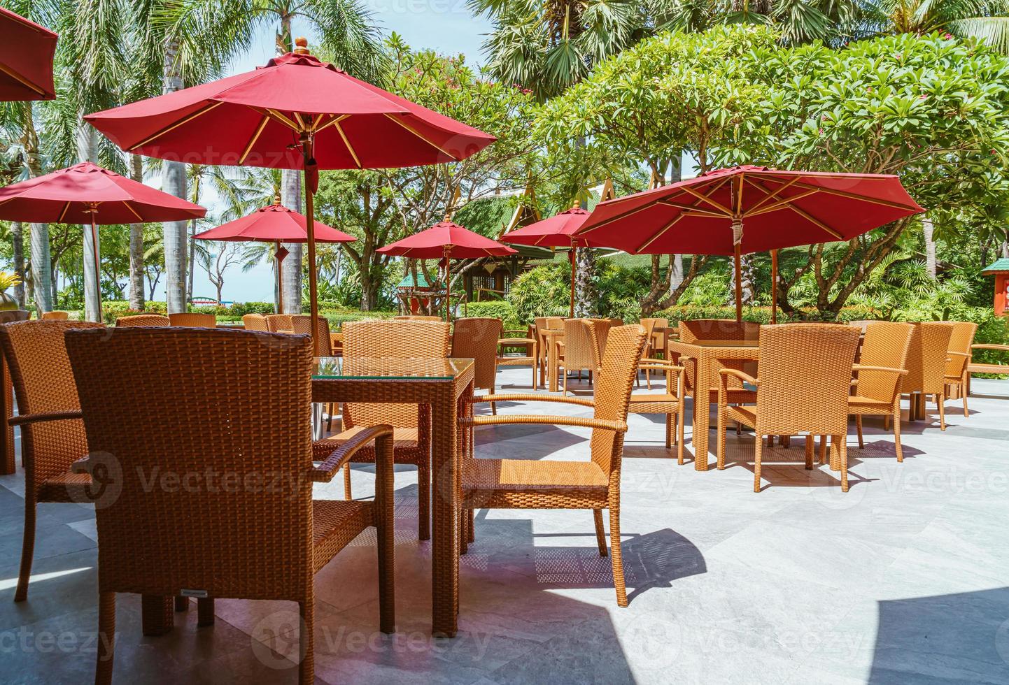 Empty outdoor patio table and chair with umbrella photo
