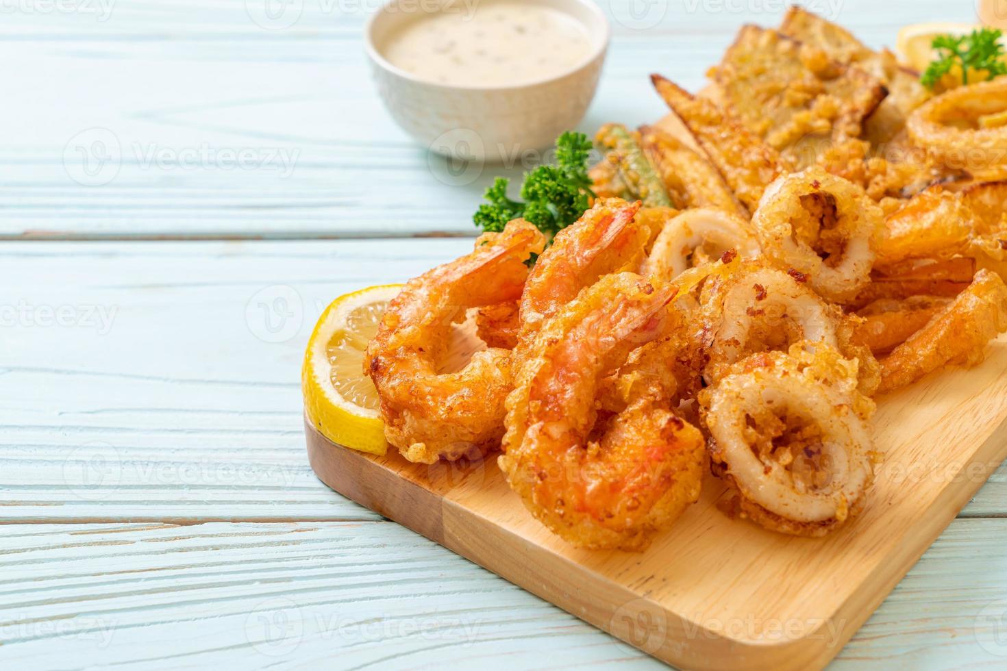 Deep-fried seafood, shrimp and squid with mix vegetables - unhealthy food style photo