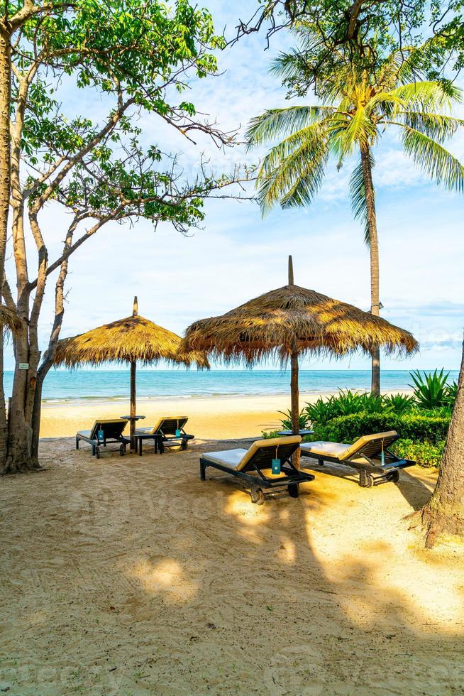 Beach chairs and umbrellas with ocean sea beach background photo