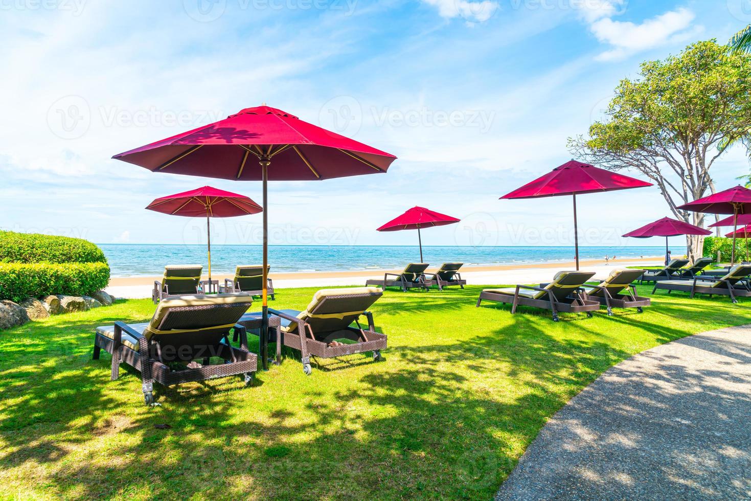 Beach chairs and umbrellas with ocean sea beach background photo