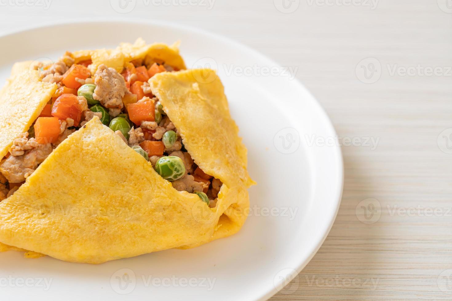 Egg wrap or stuffed egg with minced pork, carrot, tomato, and green peas photo