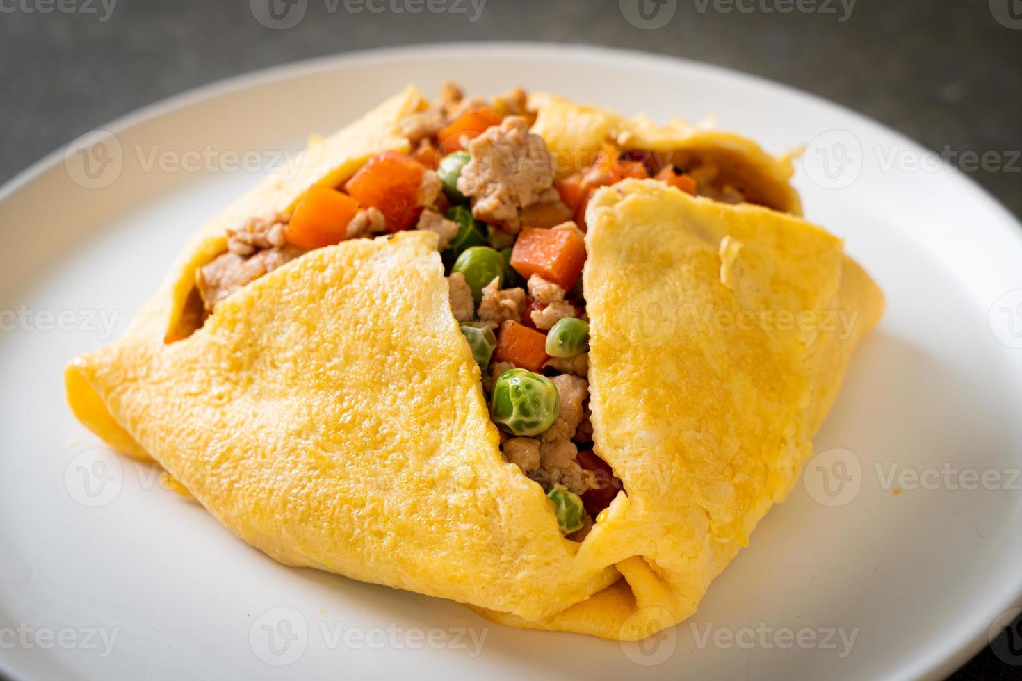 Egg wrap or stuffed egg with minced pork, carrot, tomato, and green peas photo