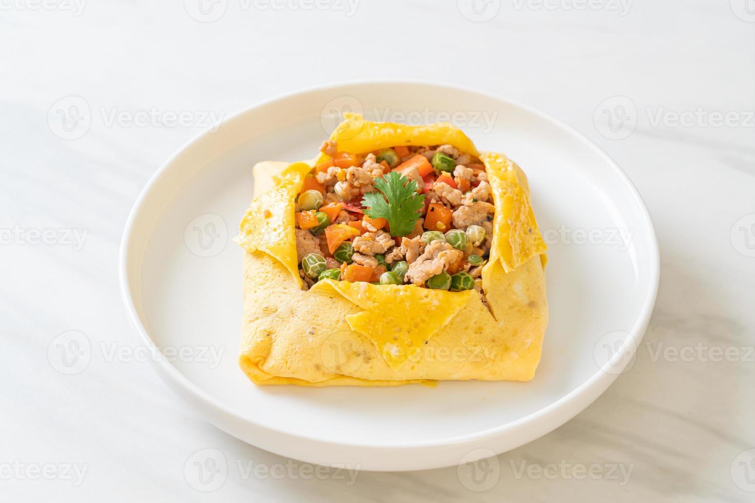 Egg wrap or stuffed egg with minced pork, carrot, tomato, and green peas photo