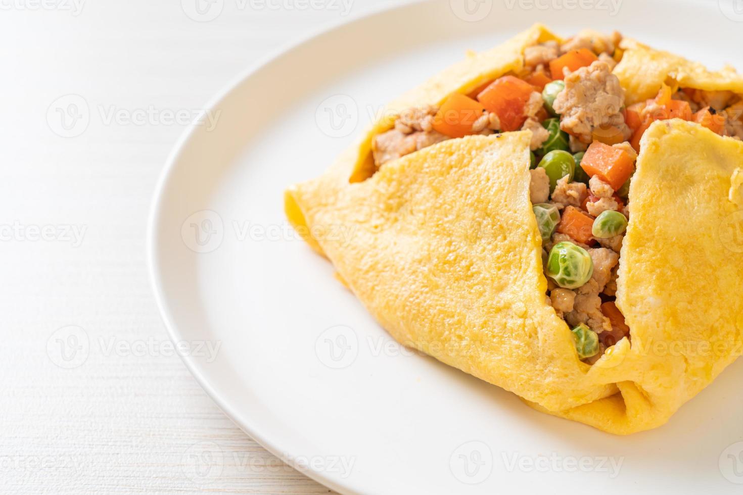 Egg wrap or stuffed egg with minced pork, carrot, tomato, and green peas photo