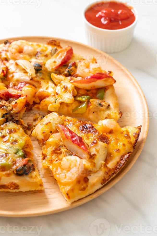 Seafood of shrimp, octopus, mussel, and crab pizza on wood tray photo