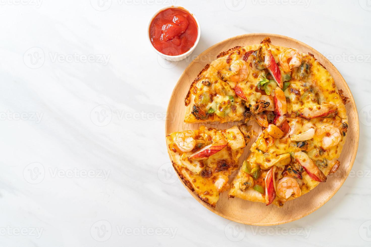 Seafood of shrimp, octopus, mussel, and crab pizza on wood tray photo