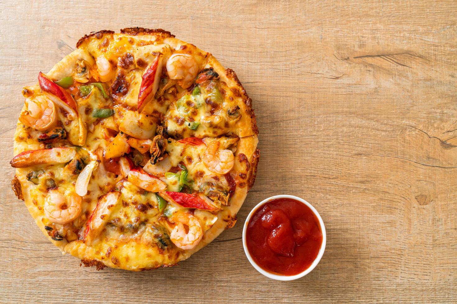 Seafood of shrimp, octopus, mussel and crab pizza on wood tray photo