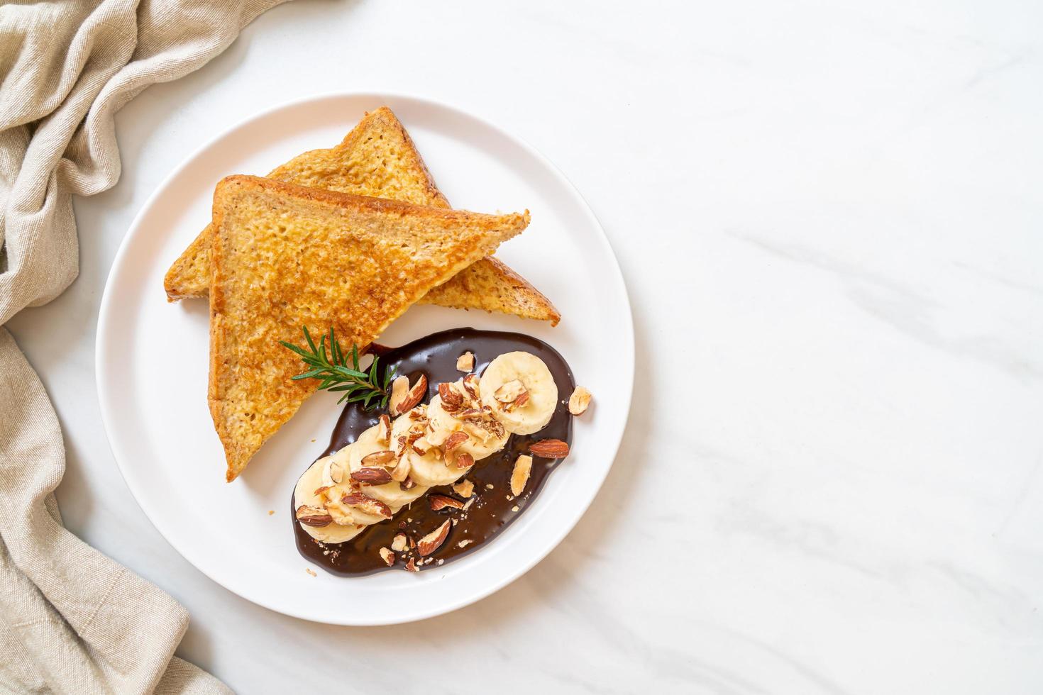 French toast with banana, chocolate, and almonds for breakfast photo