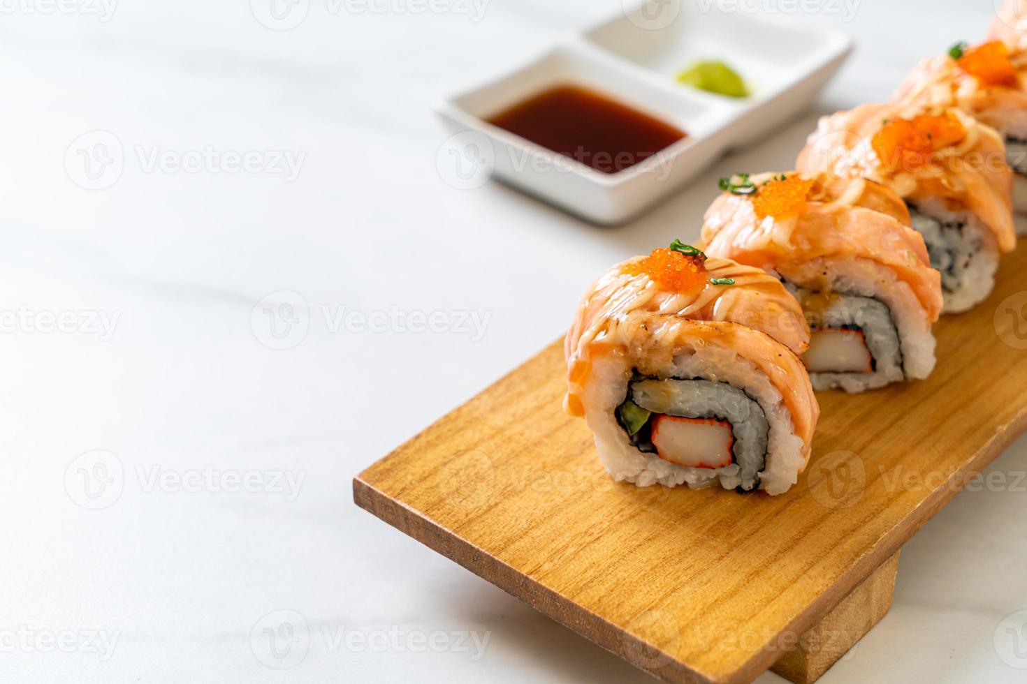 Grilled salmon sushi roll with sauce - Japanese food style photo