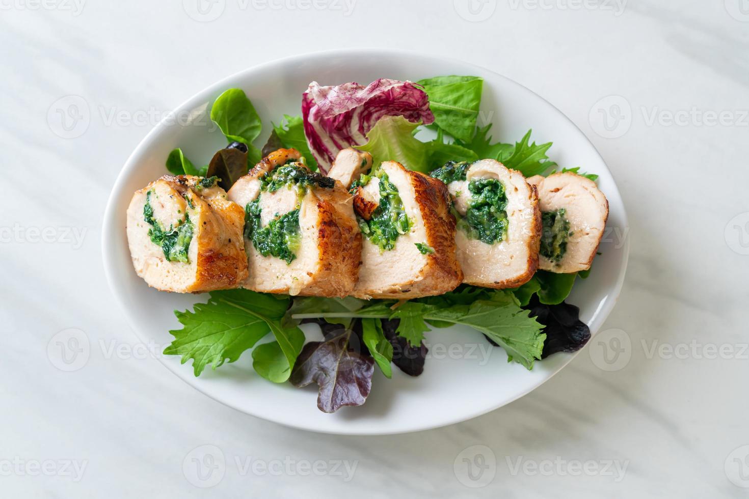 Baked chicken breast stuffed with cheese and spinach photo