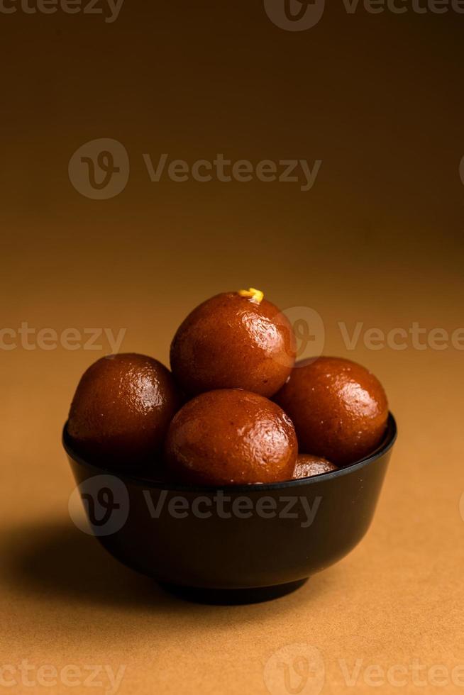 Gulab Jamun in bowl. Indian Dessert or Sweet Dish. photo