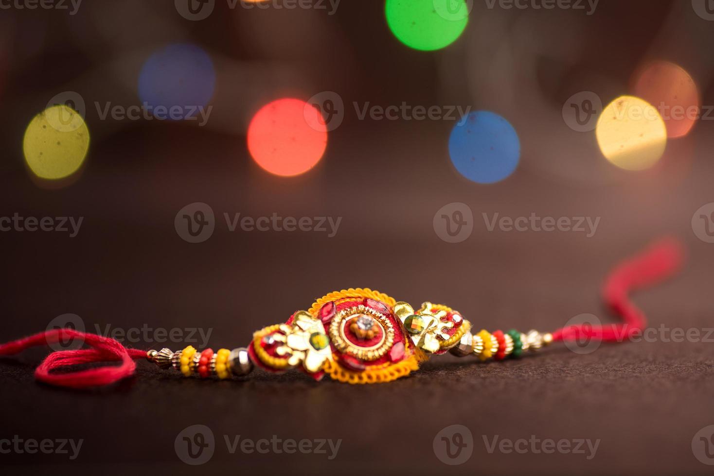 Raksha Bandhan background with an elegant Rakhi. A traditional Indian wrist band which is a symbol of love between Brothers and Sisters. photo