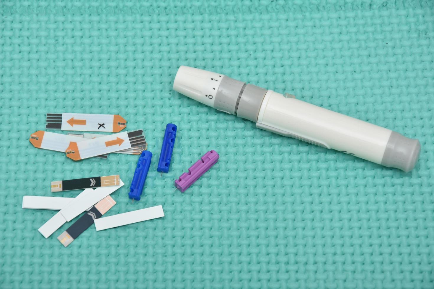 Lancet pen and diabetes glucose test strips photo