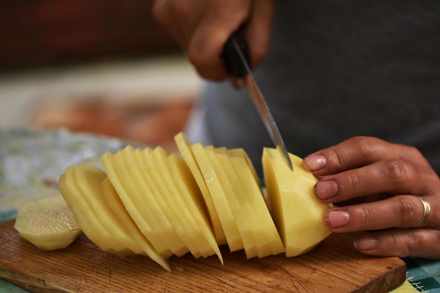 A woman slices a potato photo