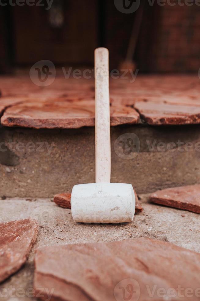 Tools for laying and installing paving slabs - cord trowel and rubber mallet photo