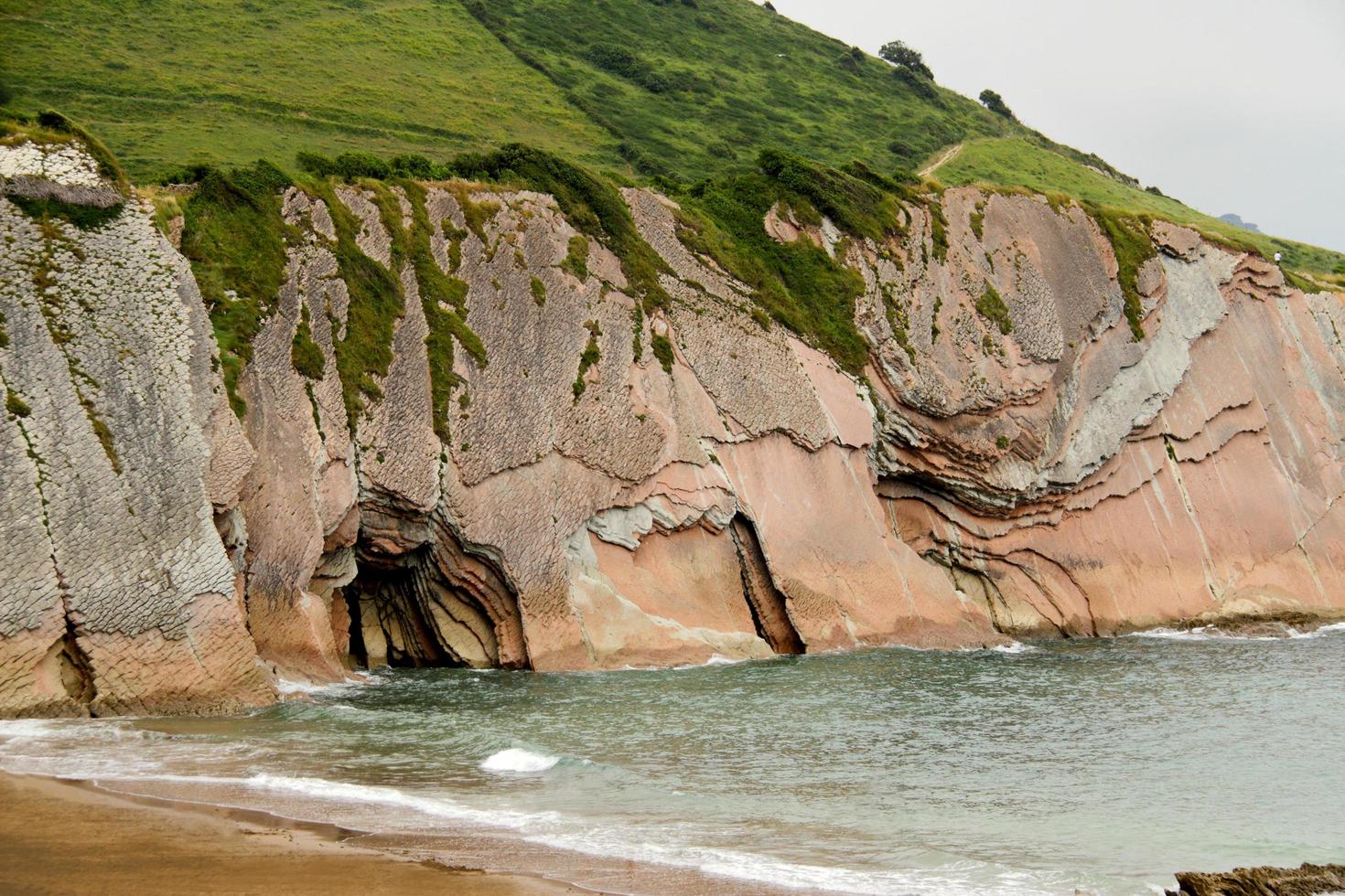 Editorial usage, Dragon stone, Itzurun beach, Santa Telma chapel, Zumaia, Basque Country, Atlantic ocean, Spain photo