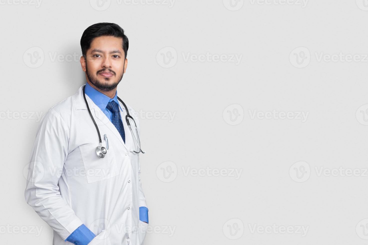 Male doctor portrait with stethoscope and arm in coat isolated on white background. Health insurance concept. photo