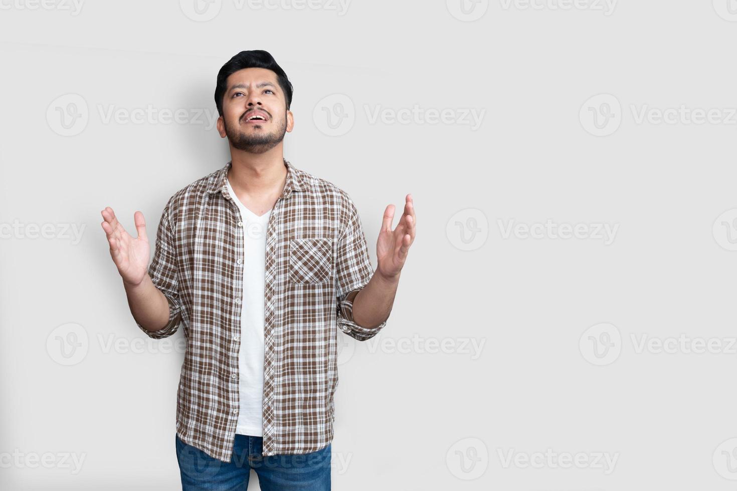 Hombre asiático adulto sobre fondo aislado loco y loco gritando y gritando con expresión agresiva y brazos levantados. concepto de frustración. foto