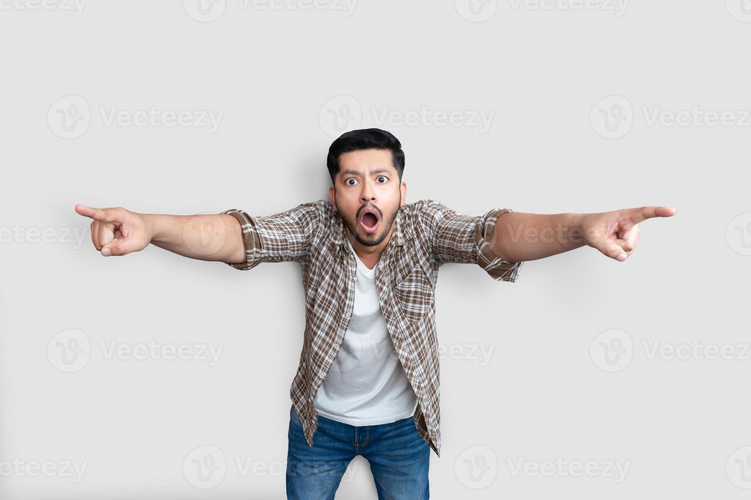 Amazed emotional man pointing at camera and screaming. Shocked young businessman shocked about failure. Incredible loss concept photo