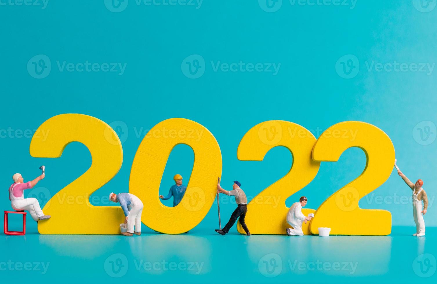 Equipo de trabajadores de personas en miniatura pintura número 2022 foto