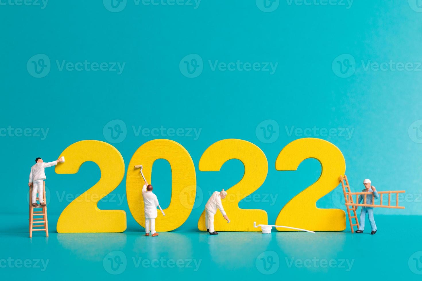 Equipo de trabajadores de personas en miniatura pintura número 2022 foto