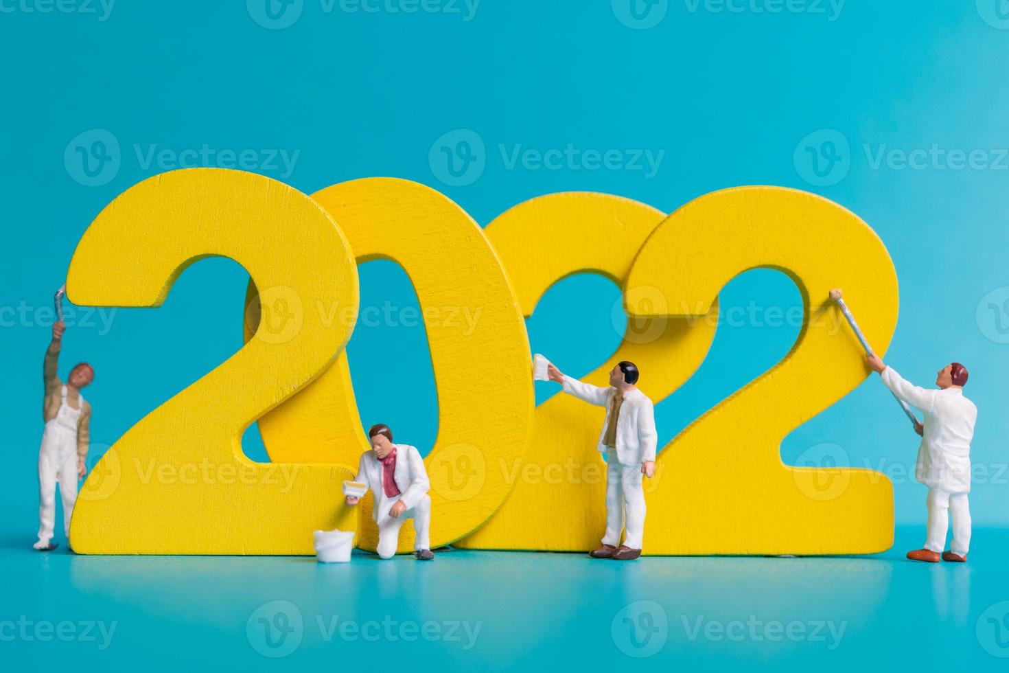 Miniature people worker team painting number 2022 photo