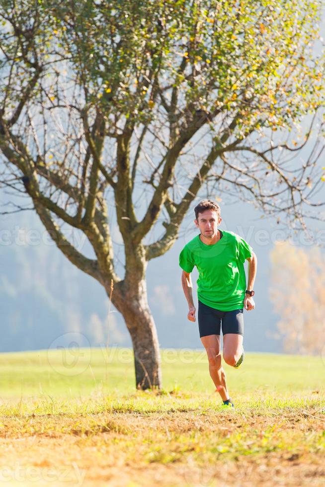 Race in the mountains an athlete trains in the fall photo