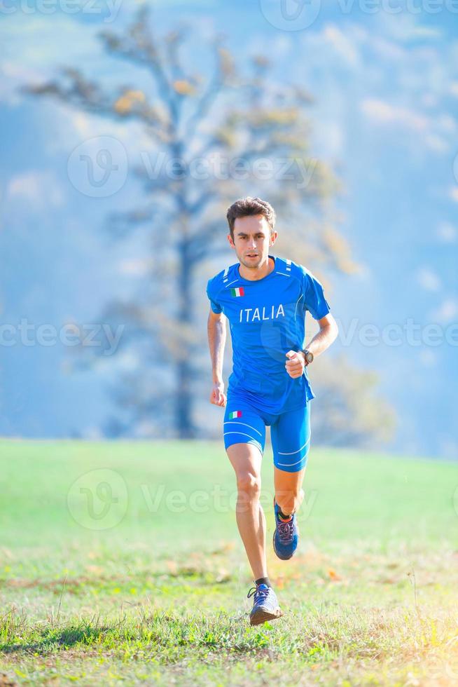 Athlete running in the mountains of the Italian national team in training photo