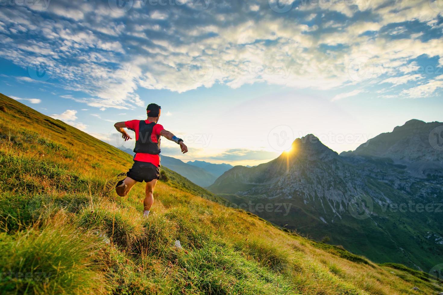 Runner skyrunner on a mountain meadow at dawn photo