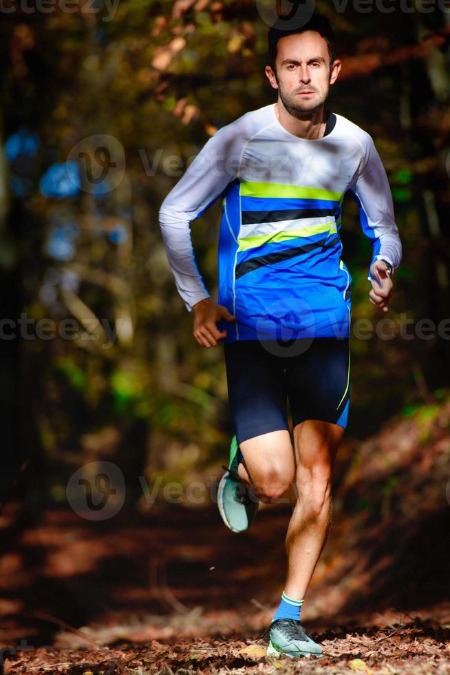 Running in the autumn forest athletic preparation for marathon photo