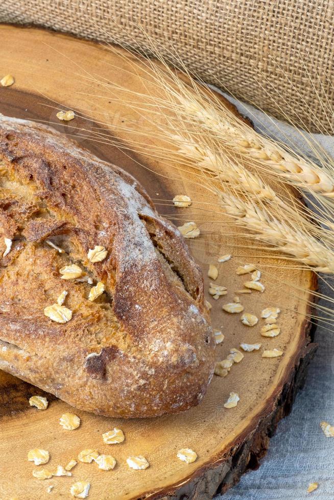 Delicious fresh baked bread on rustic background. photo