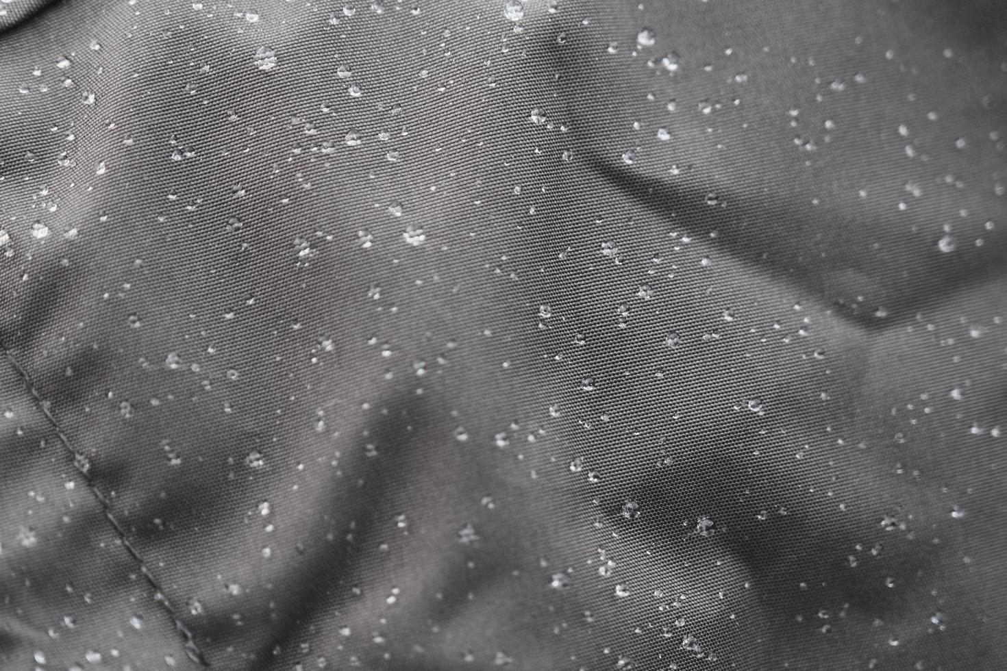 Wet raincoat made of smooth and tight gray waterproof fabric photo