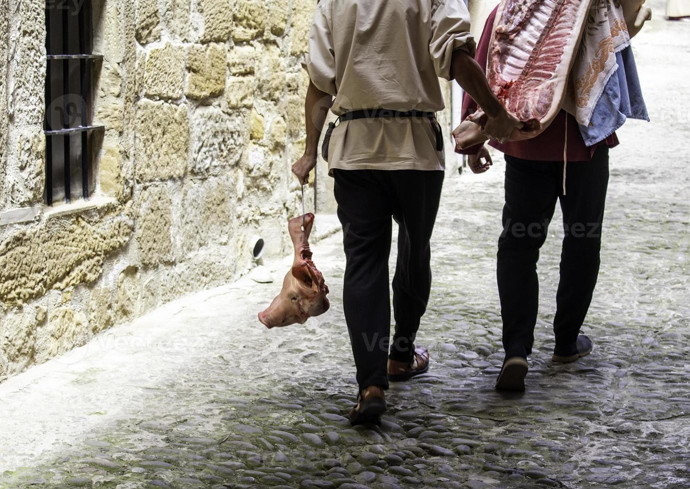 Man carrying dead pig photo