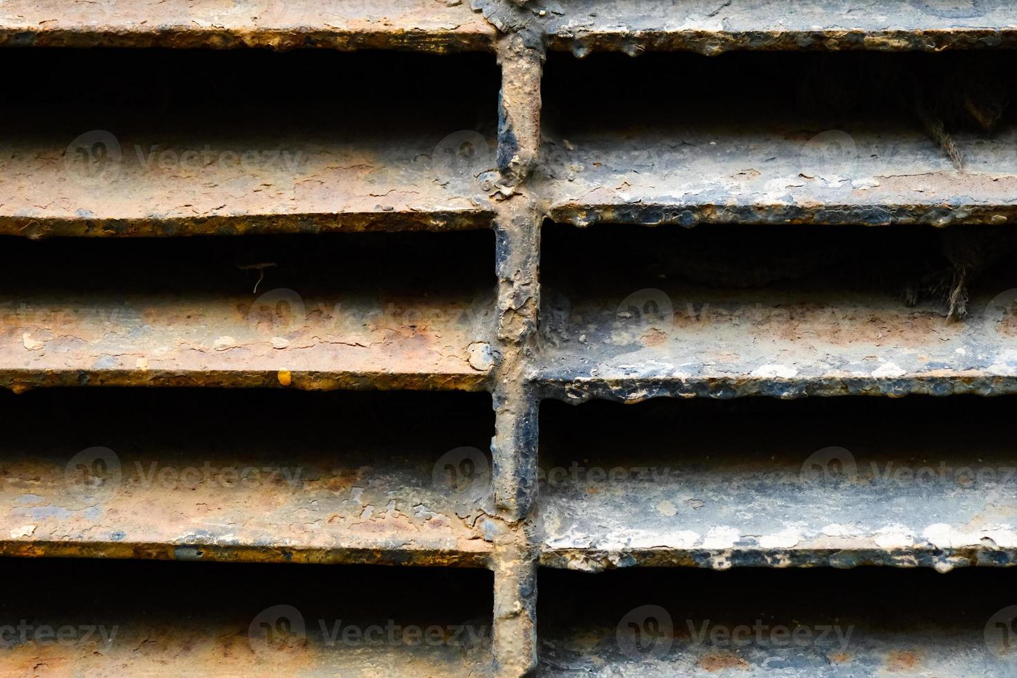 Close-up of rusty metal lattice wall photo