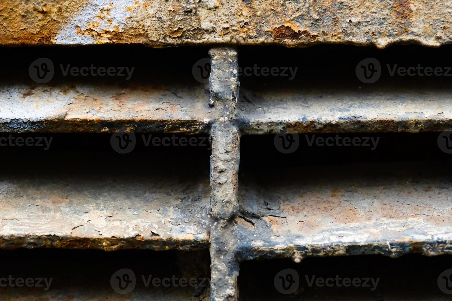 Close-up of rusty metal lattice wall photo