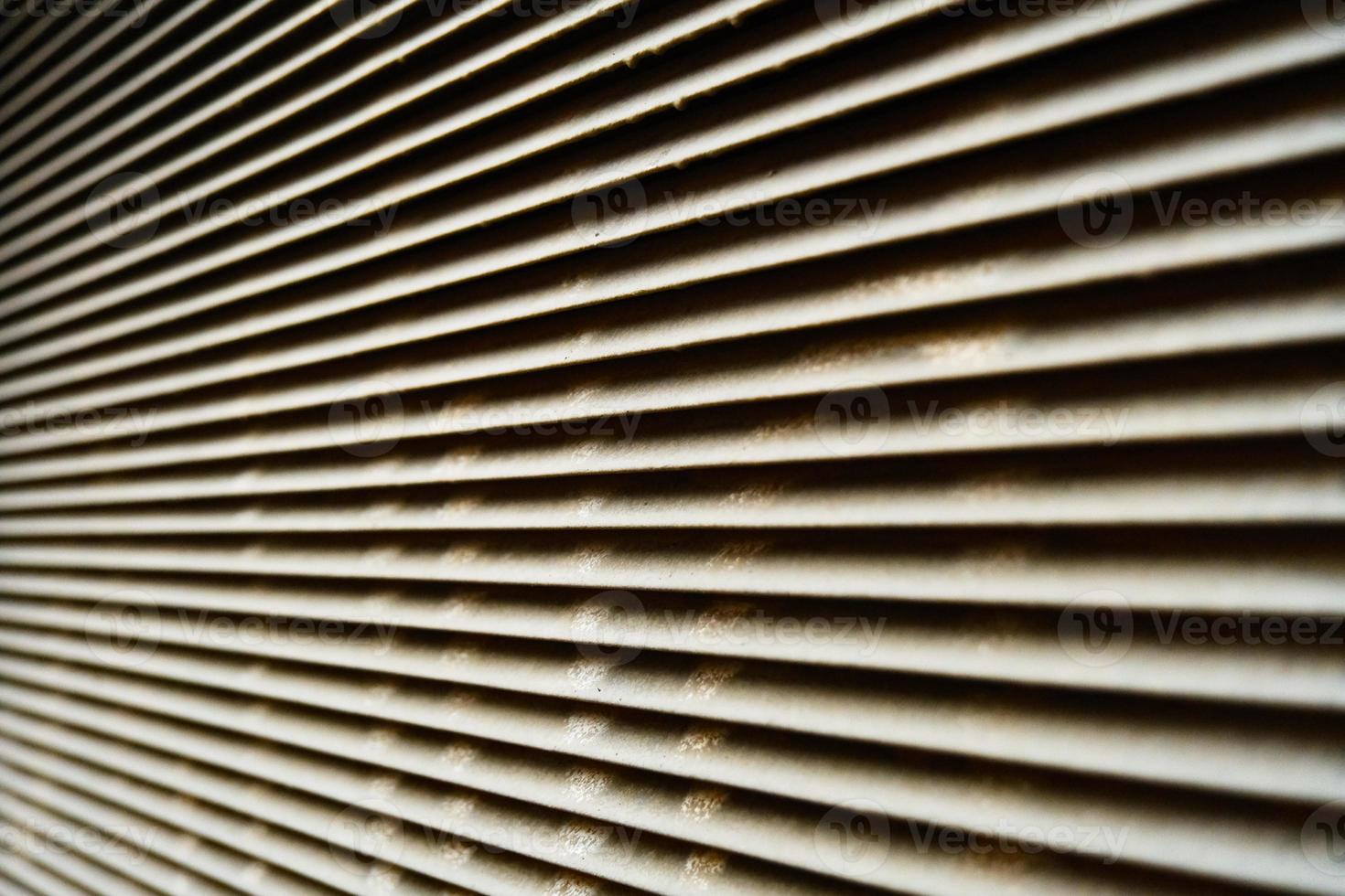 Dirty stained metallic jalousie pattern close-up photo